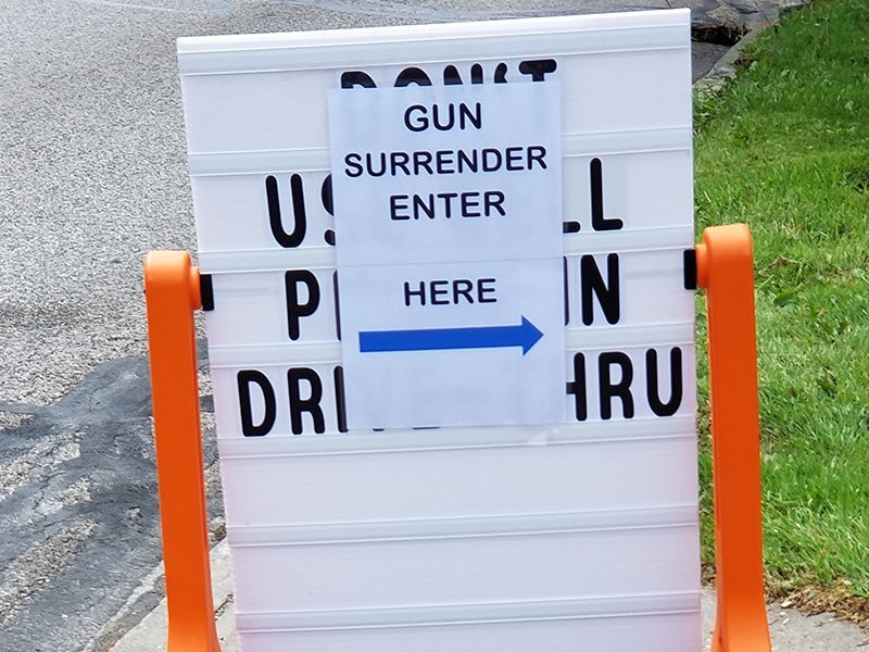 gun surrender event sign